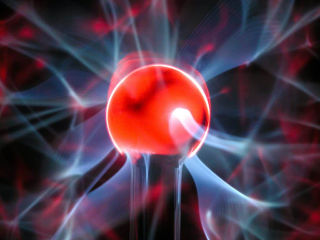 Dynamic close-up of a plasma lamp showing colorful electric streamers.